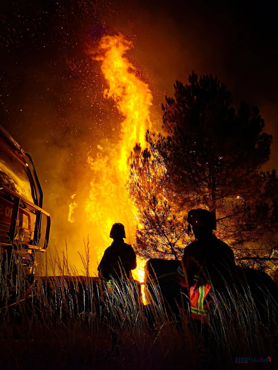 firemen fighting a bush fire at night