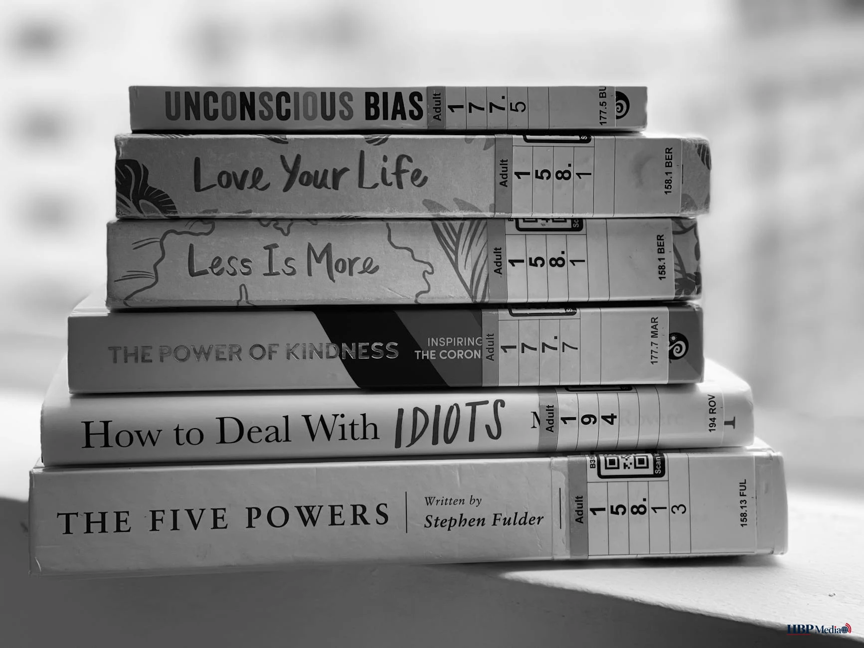 grayscale photo of stack of books