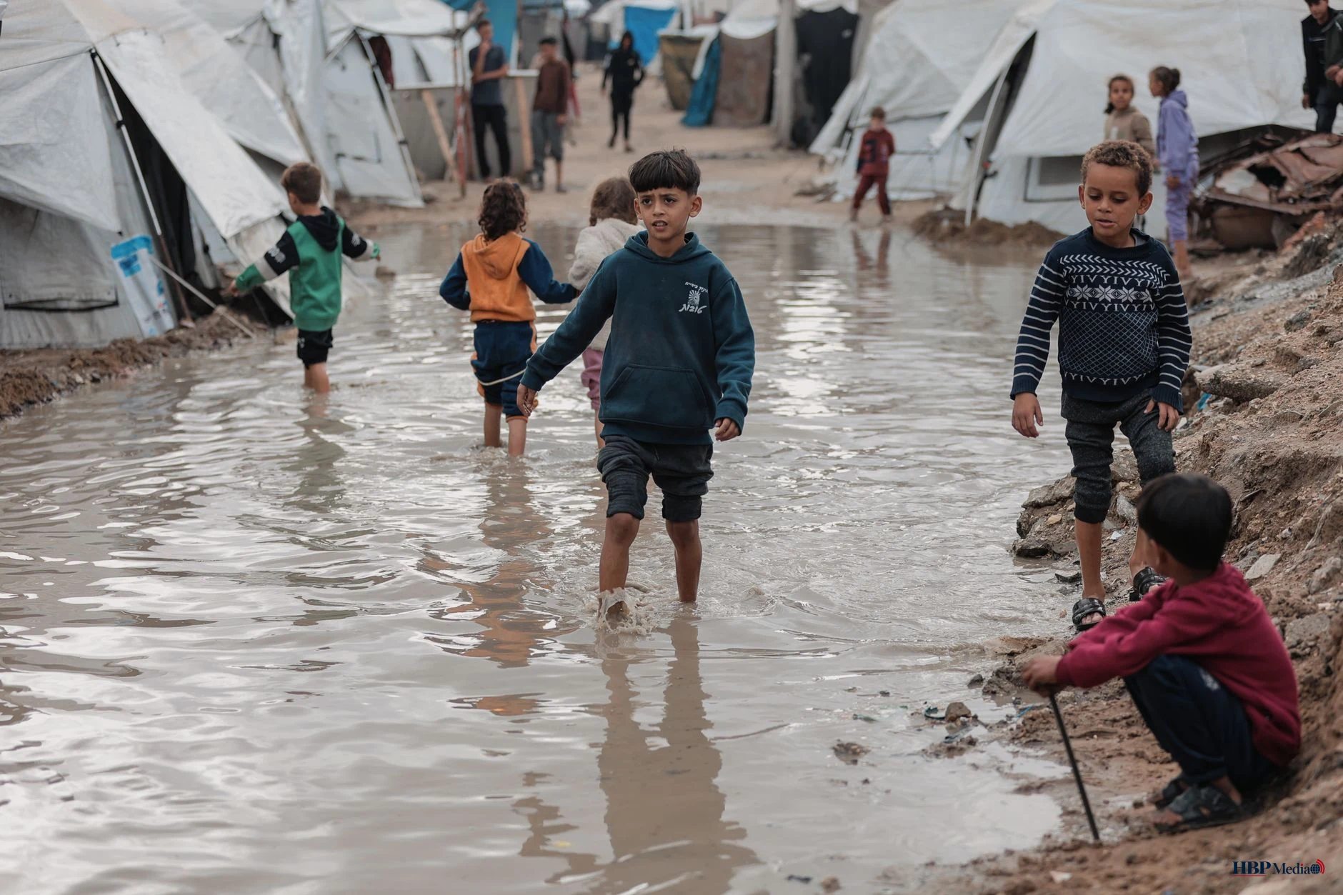 children playing in flooded gaza camp