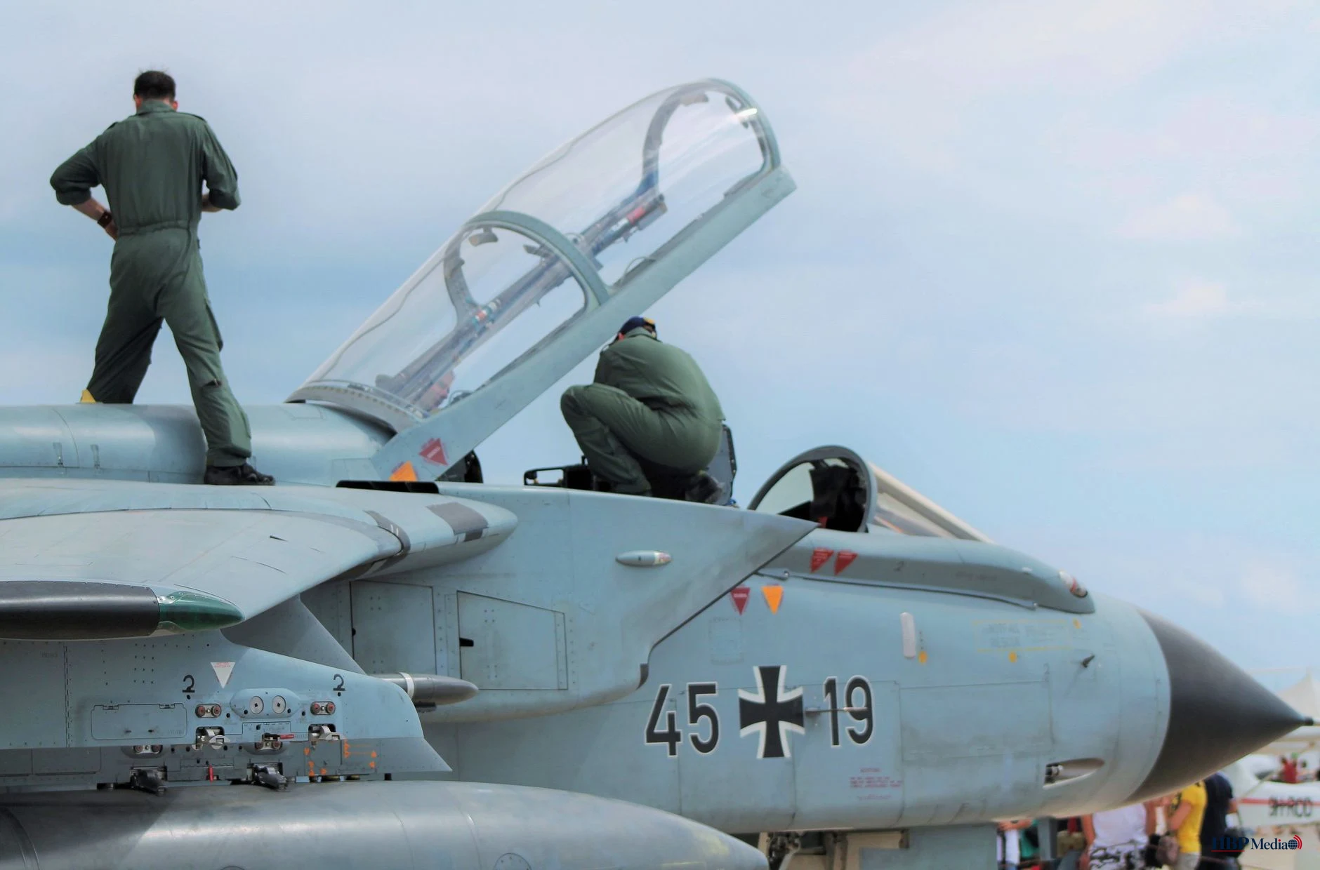 anonymous aviators preparing for flight on attack aircraft