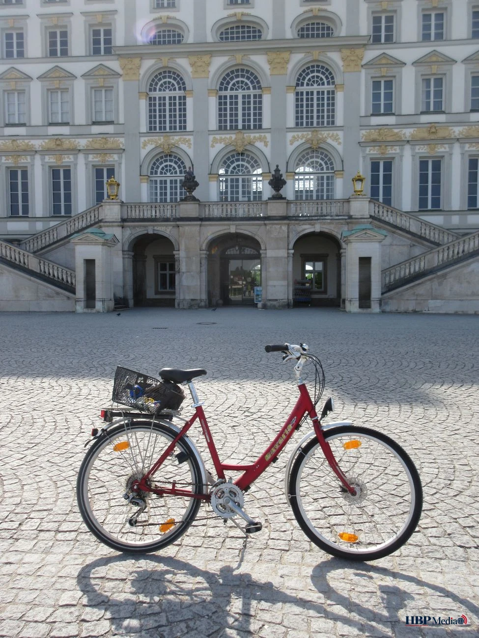 red bicycle in front of historic building