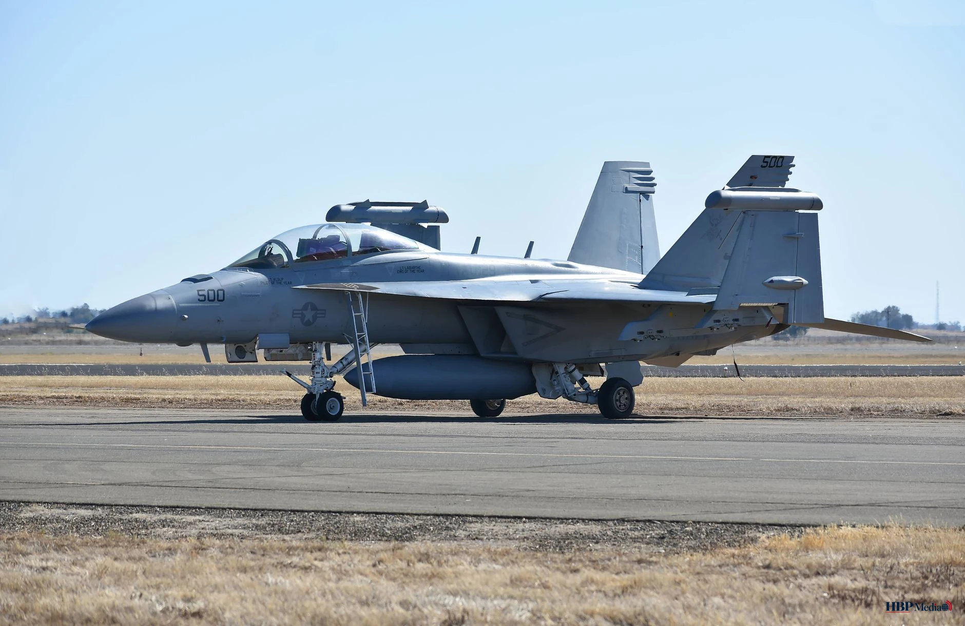 military fighter jet on runway in daylight