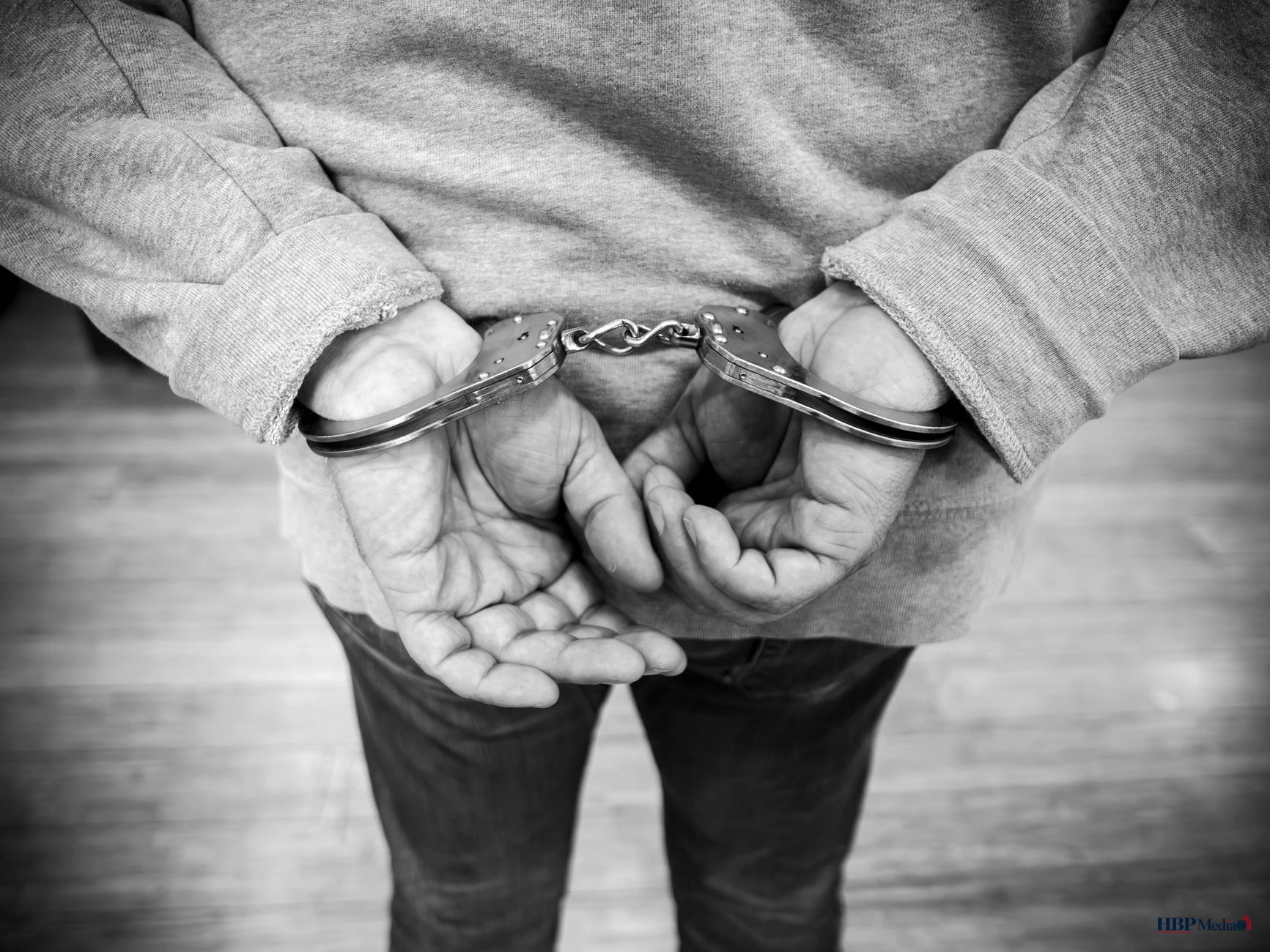 black and white image of person in handcuffs