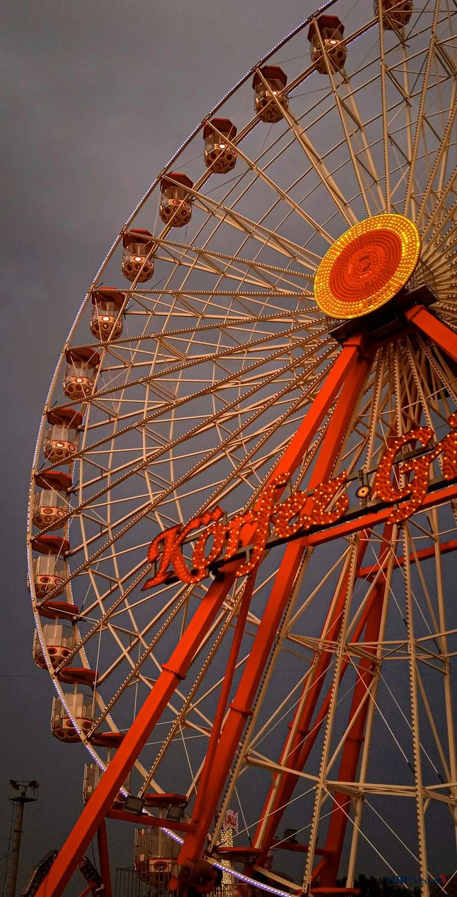 ferris wheel against dramatic sky
