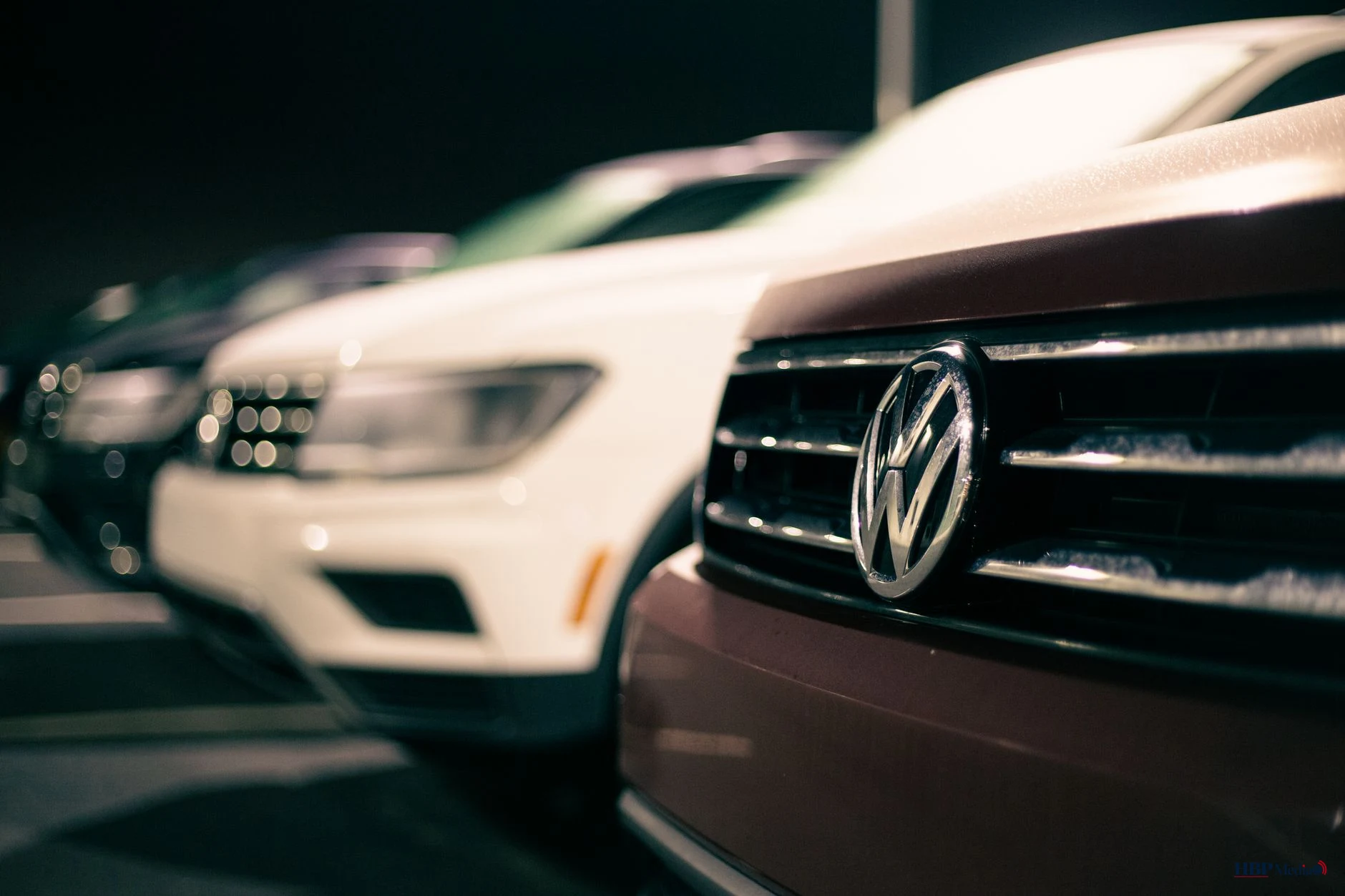 row of shiny vehicles on parking lot of car market