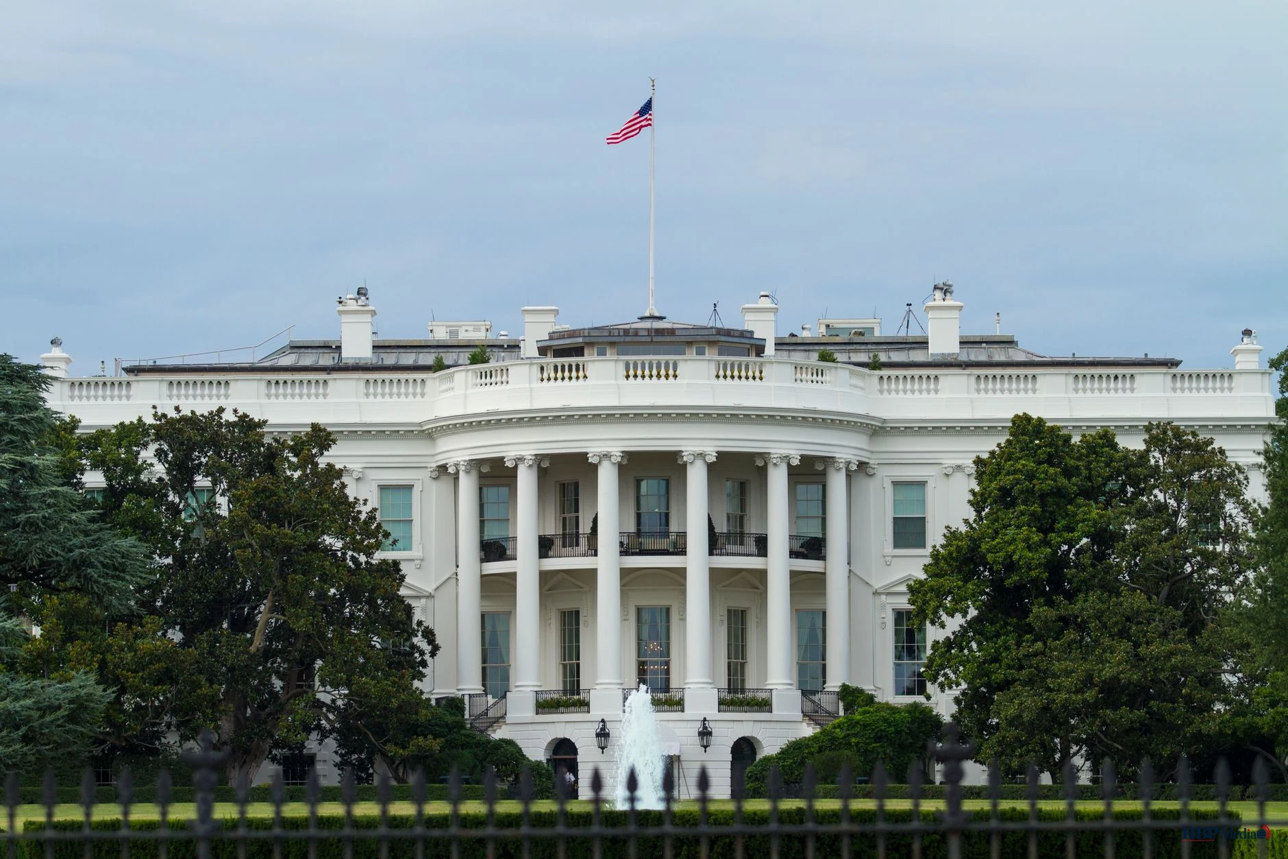 white concrete building with flags on top