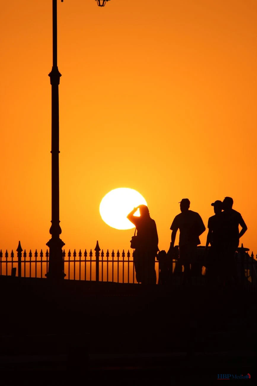 silhouetted people against moroccan sunset