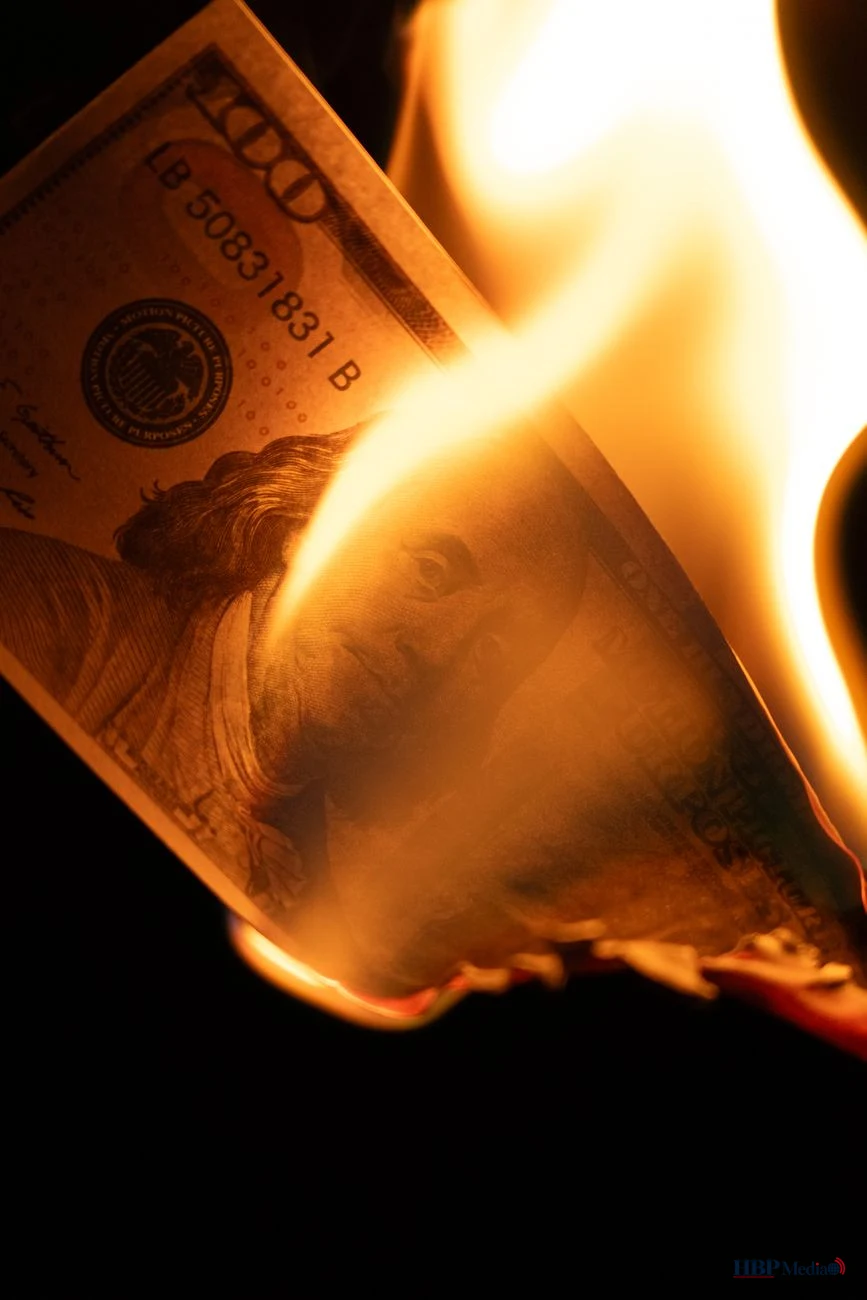 dramatic burning of a one hundred dollar bill