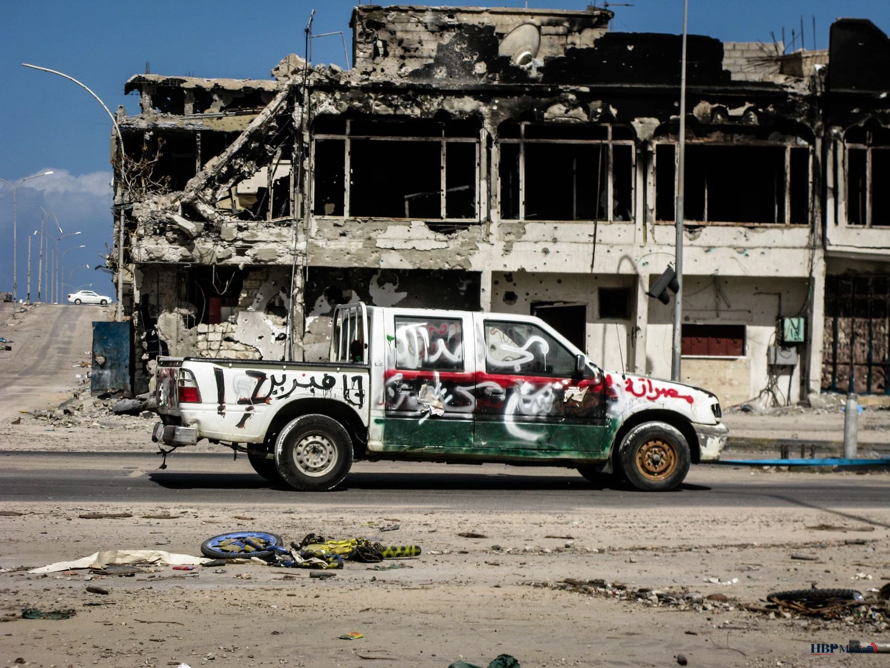 war torn urban landscape with vehicle in sirte