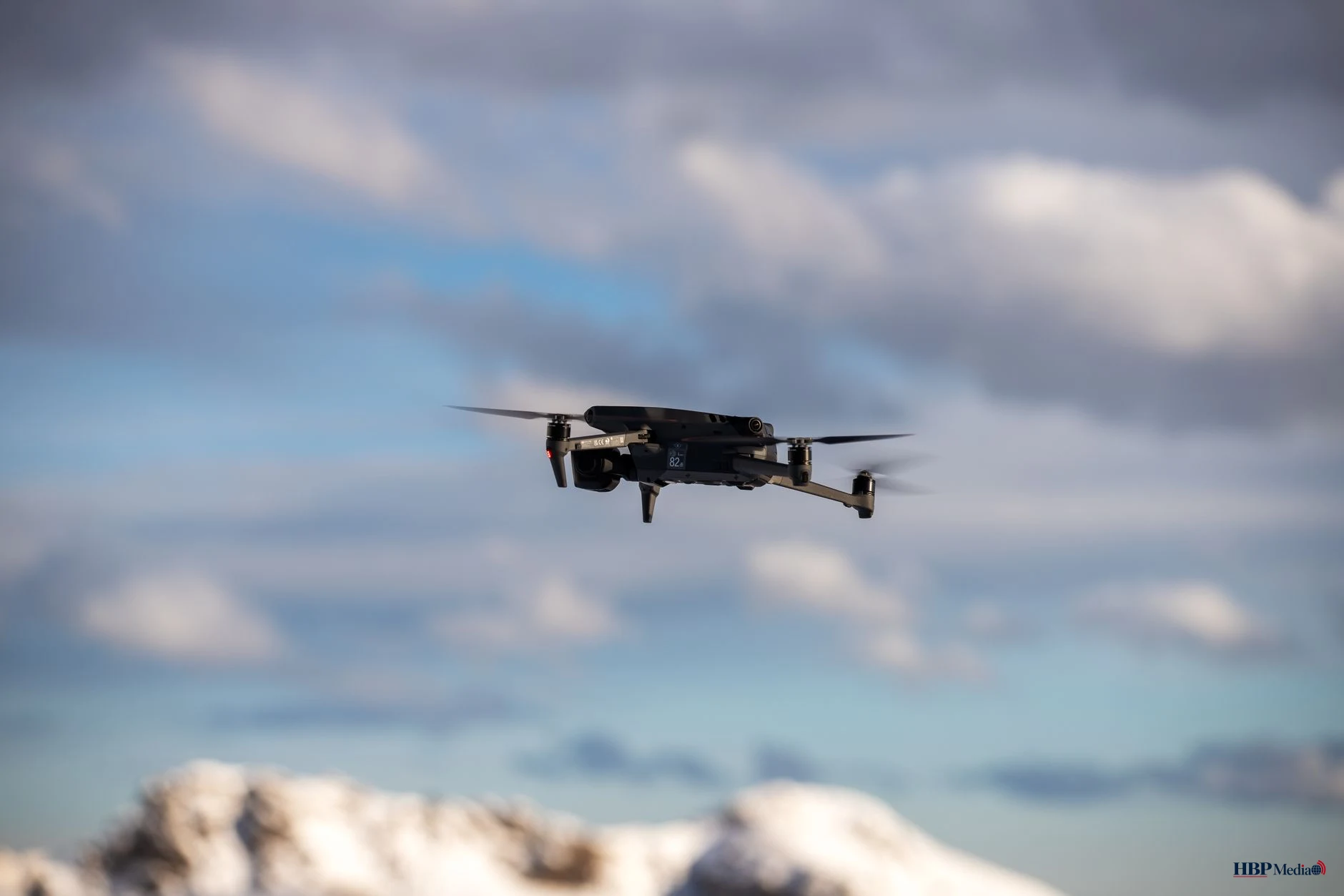 drone in flight over snowy mountains