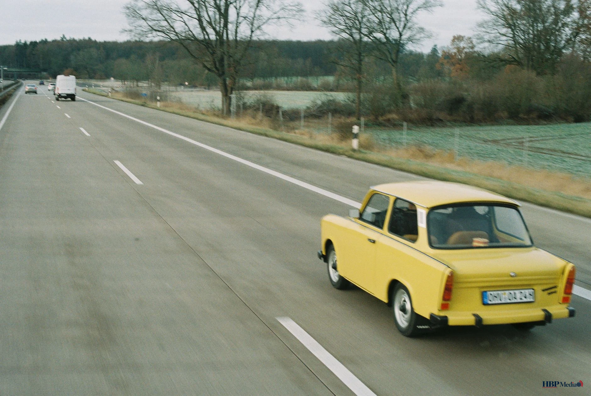 yellow trabant running on highway