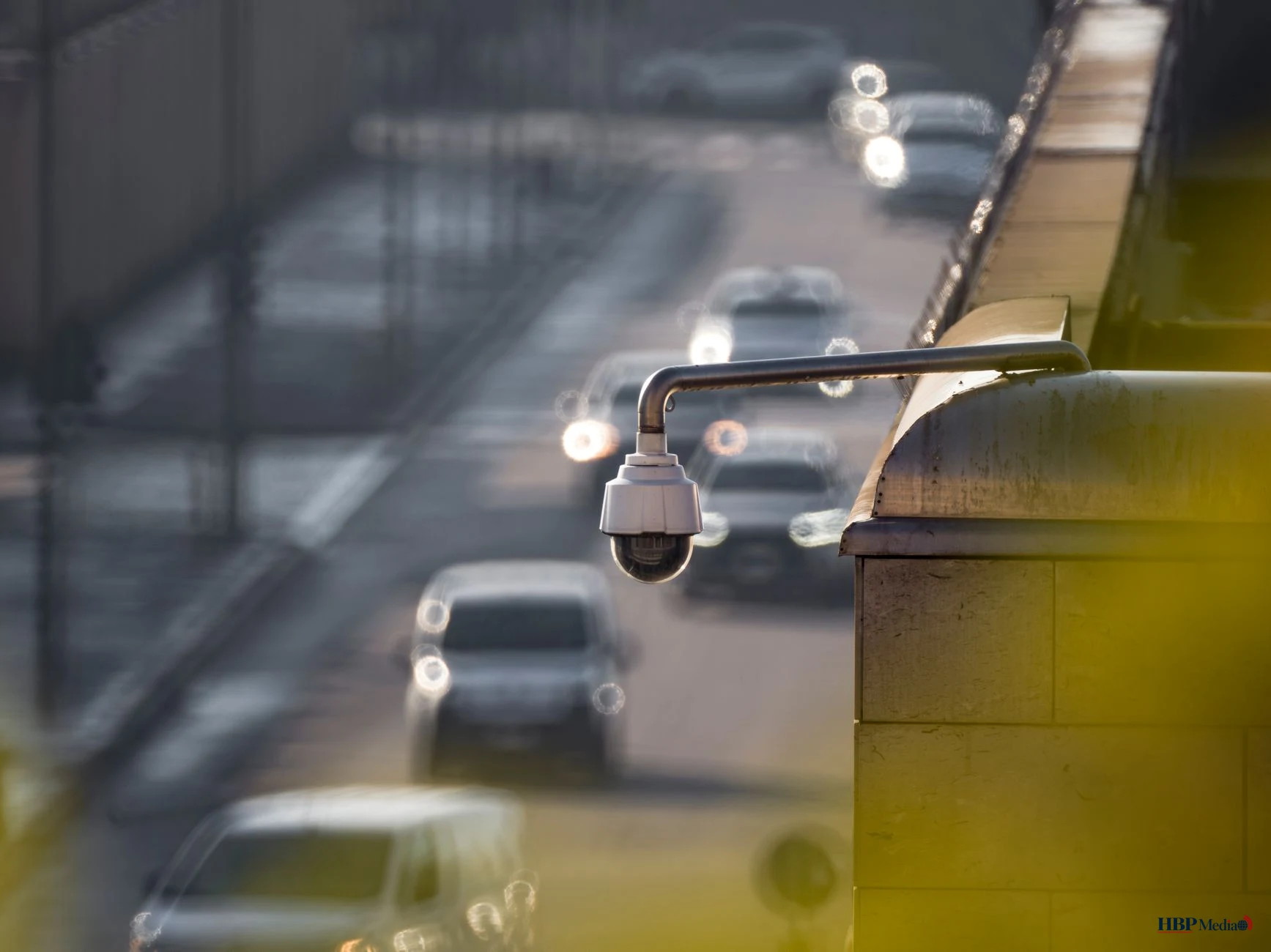 close up of security camera overlooking busy street