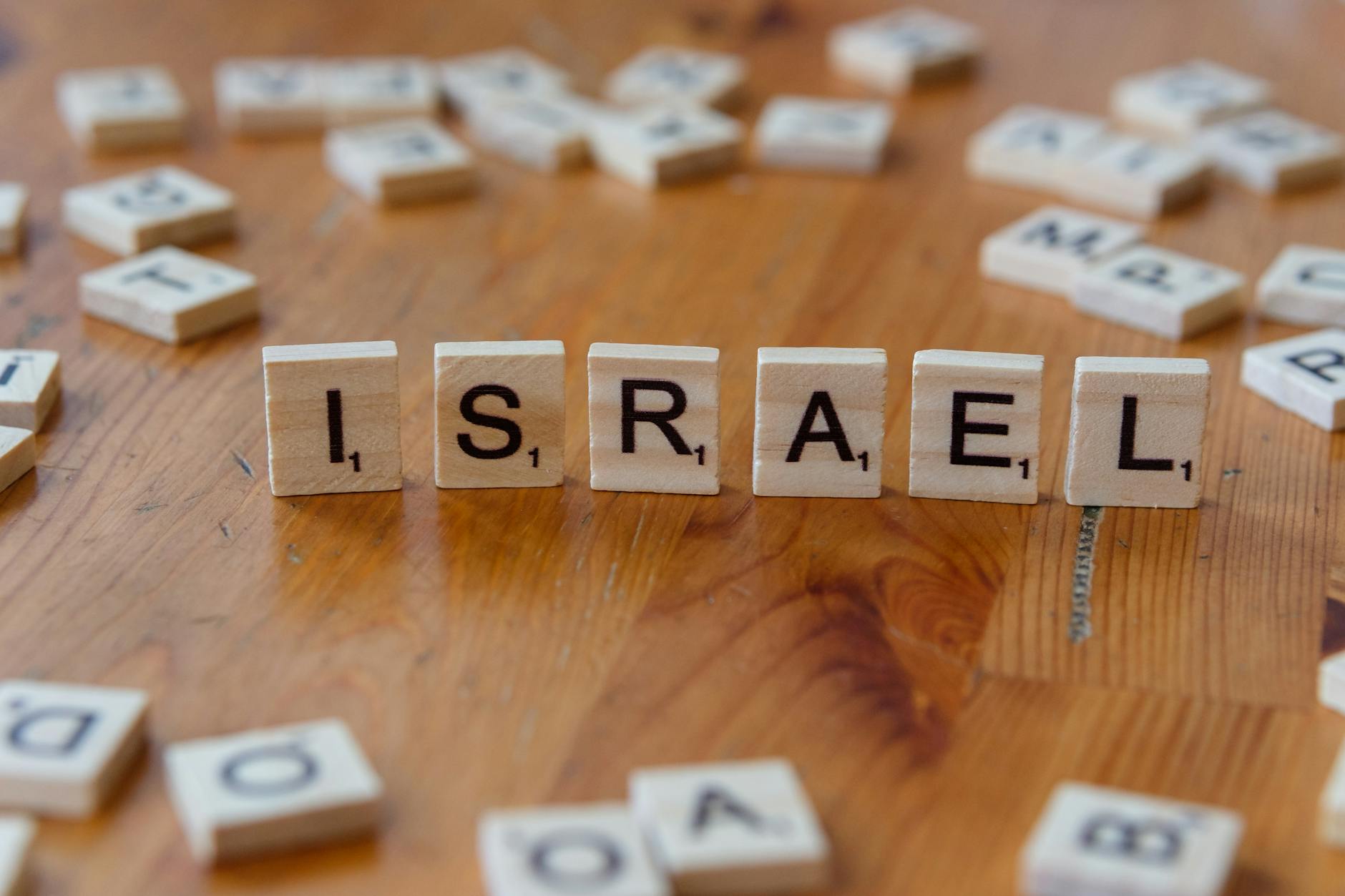 scrabble tiles spelling israel on a table
