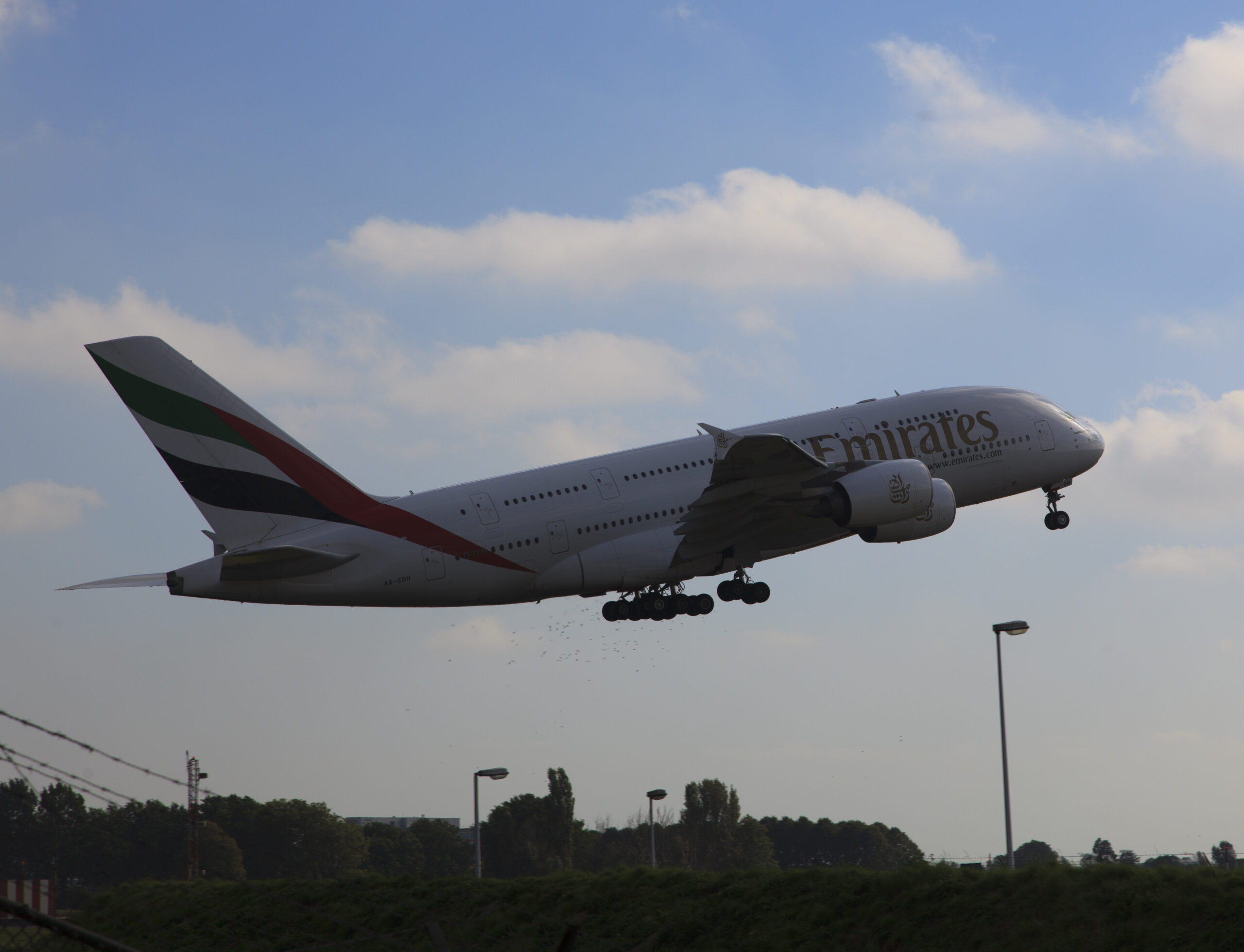 Luchthaven Schiphol met vliegtuigen aan de gate tijdens zonsondergang